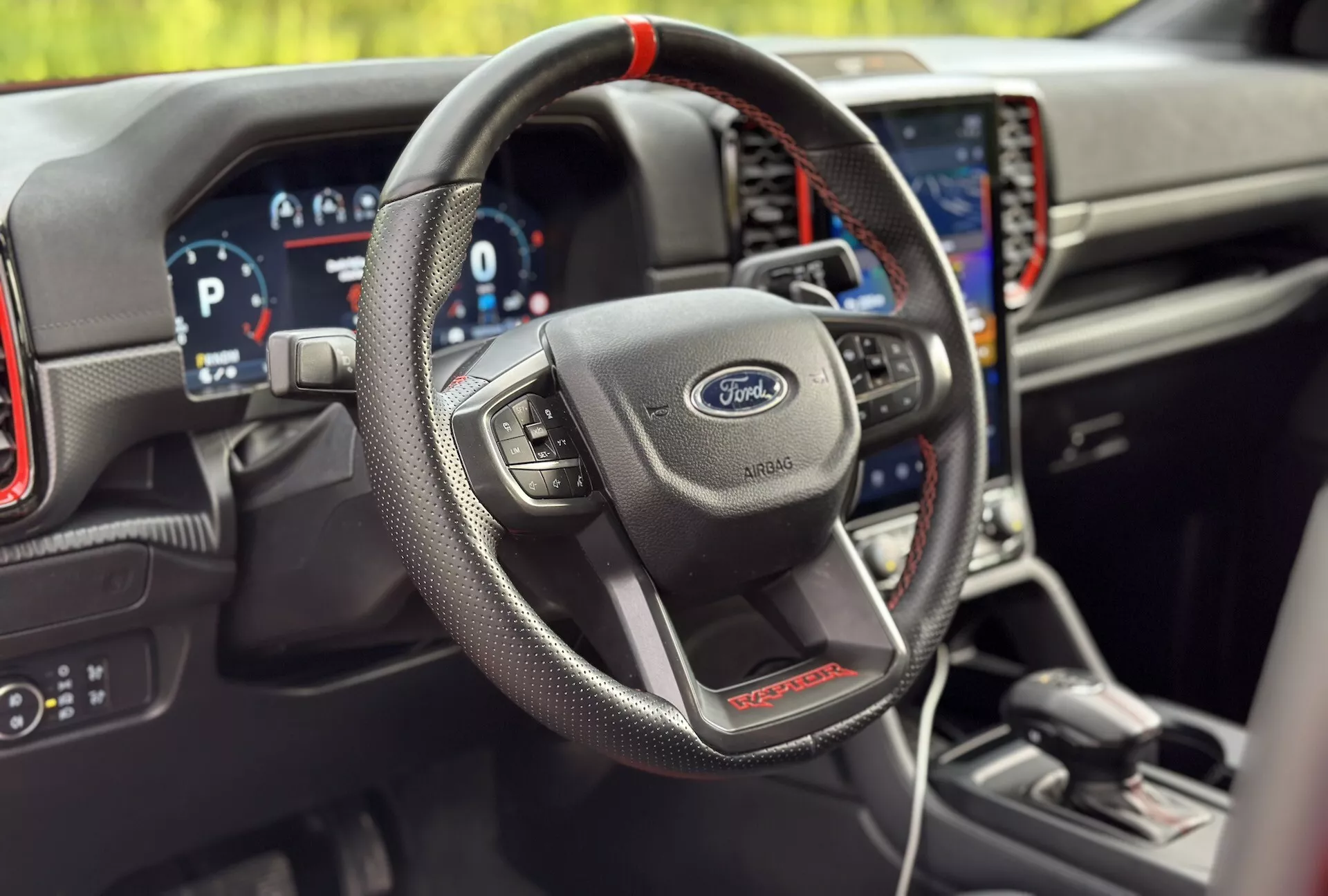 Interior del Ford Ranger 2022, destacando el volante forrado en cuero con controles multifunción, cuadro de instrumentos digital y sistema de navegación integrado en la variante deportiva ST