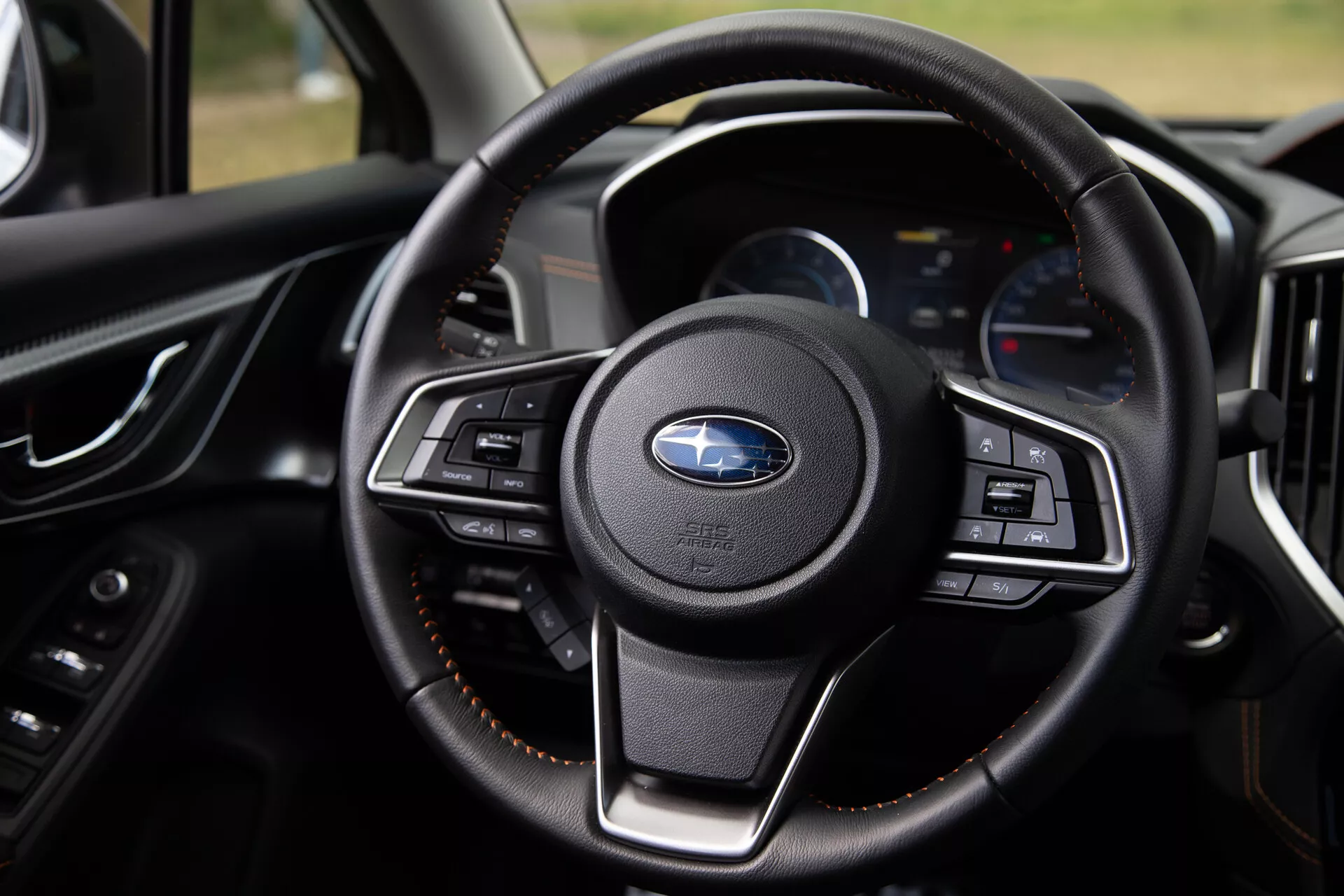 Vista detallada del volante del Subaru XV 2021 destacando sus botones multifunción, revestimiento de cuero de lujo y tablero moderno con pantallas digitales