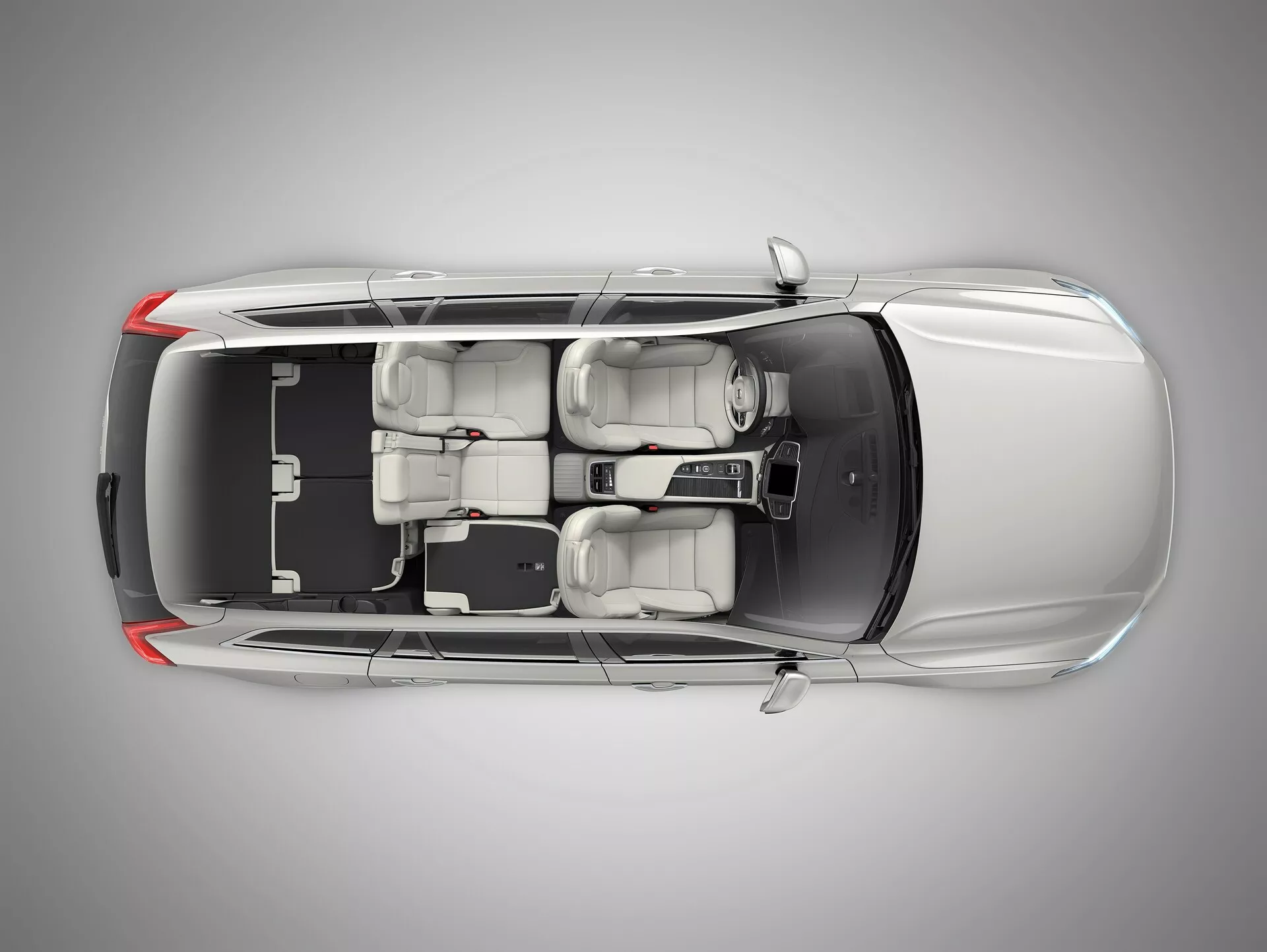 Vista desde arriba del Volvo XC90 2015 (2ª generación), que muestra el techo, el capó, el maletero y las ventanas. Características incluyen un techo solar centralizado, ventanas delineadas y una línea de techo elegante que sugiere eficiencia aerodinámica. La silueta del vehículo revela un sedán de cuatro puertas con asientos en dos filas, con capacidad para cinco pasajeros.